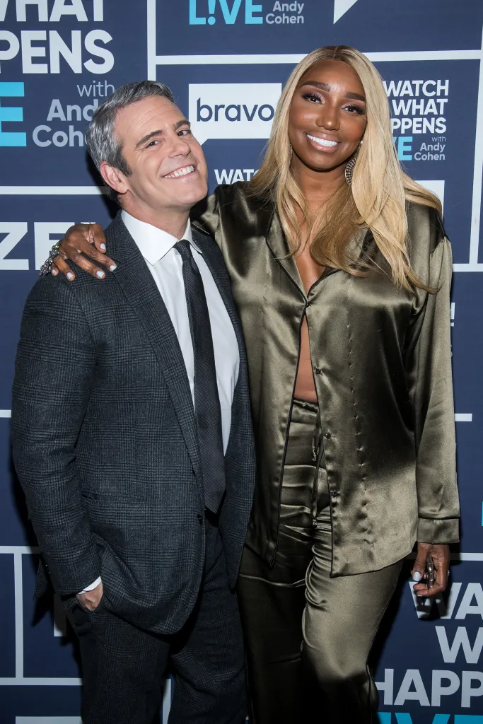 Andy Cohen and NeNe Leakes smiling at the camera during an episode of 