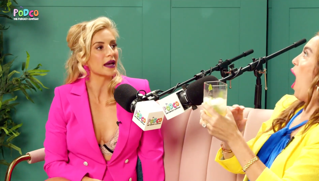 Annaliese van der Pol talking on Podco, The Podcast Company, while the host holds a drink and reacts.