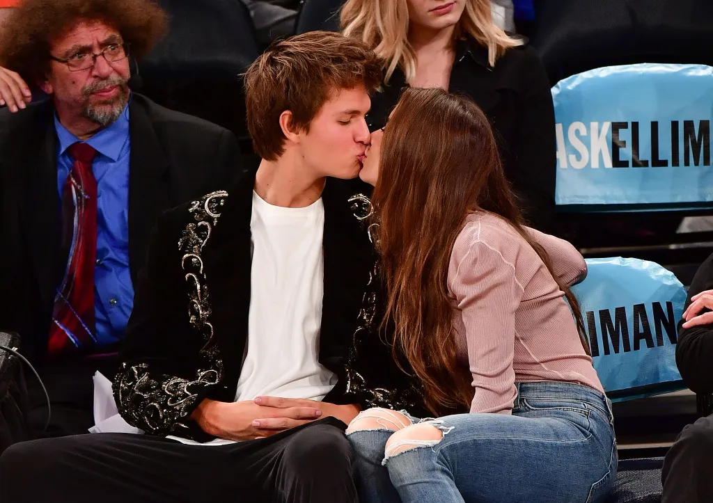 Ansel Elgort and Violetta Komyshan kissing at a New York Knicks vs Boston Celtics preseason game.