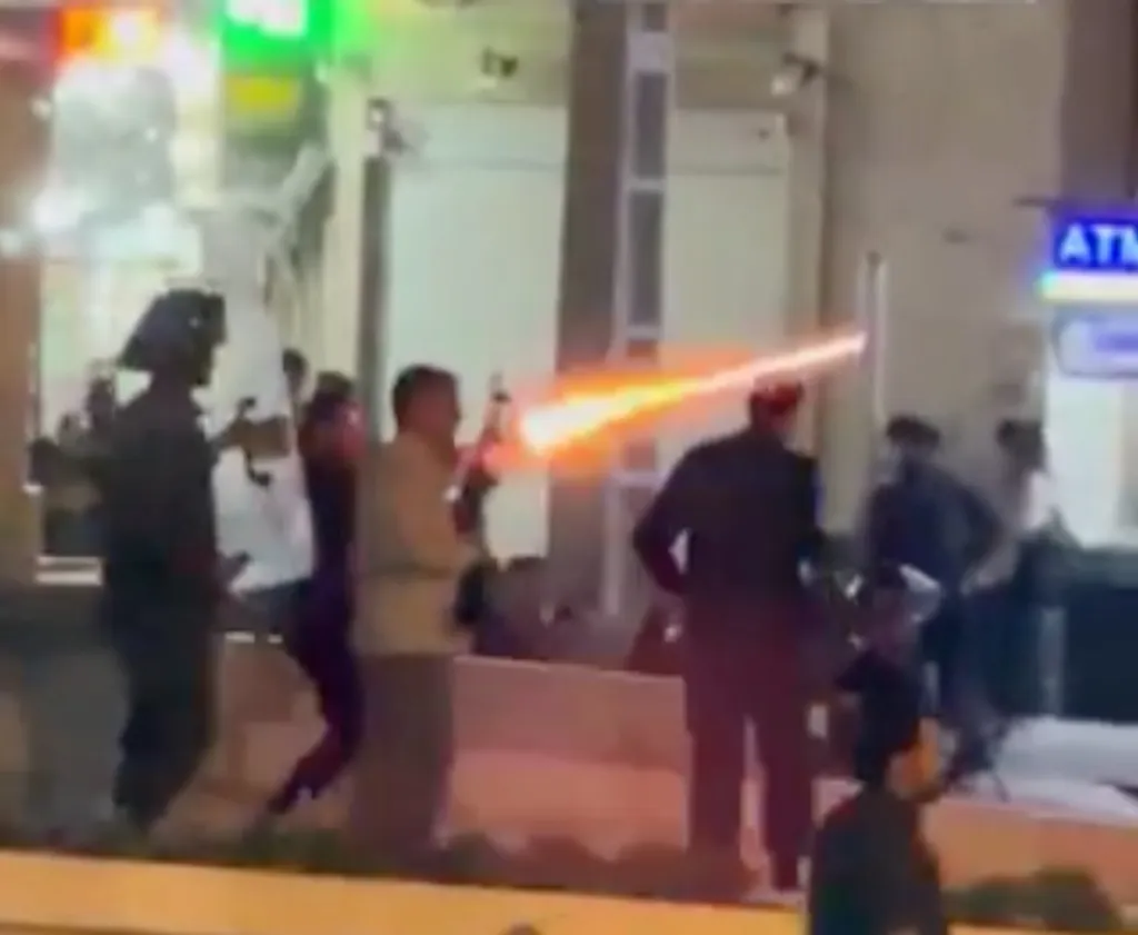 Armed men firing guns in Bandar Kangan, Iran.