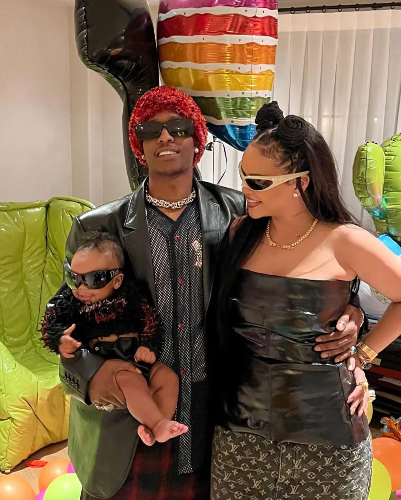 ASAP Rocky holding his infant son, RZA, with Rihanna by his side.