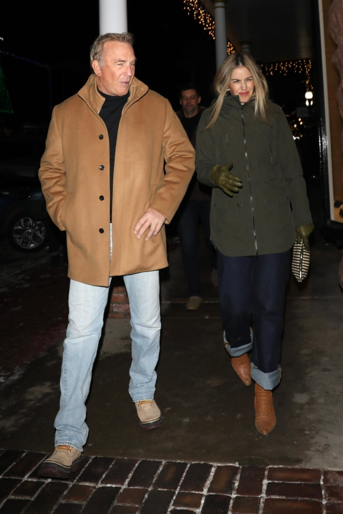 Kevin Costner and Kelly Noonan Gores walk together on a street in Aspen.