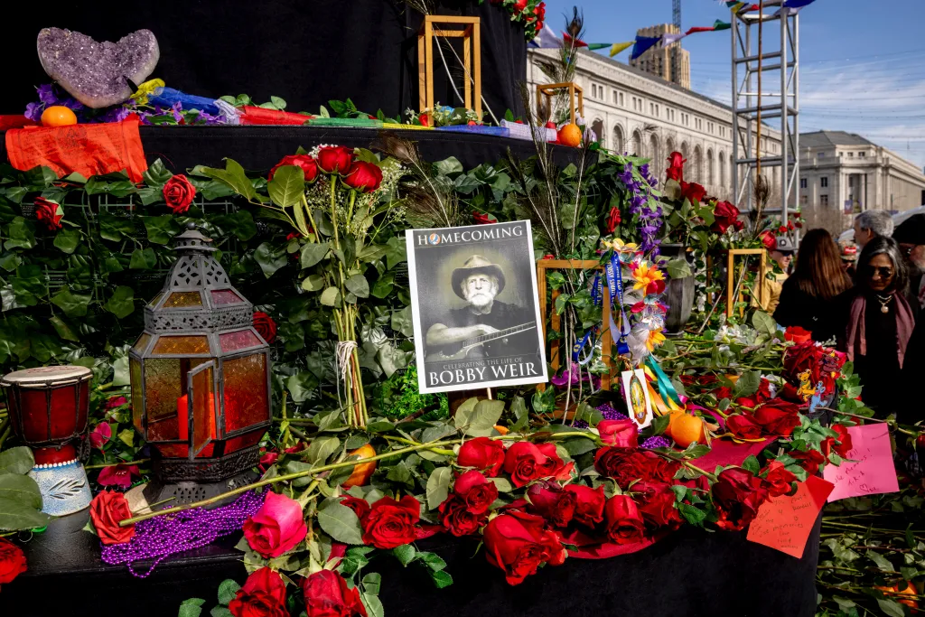 A photo of Bob Weir is displayed on a makeshift memorial at Civic Center Plaza in San Francisco.