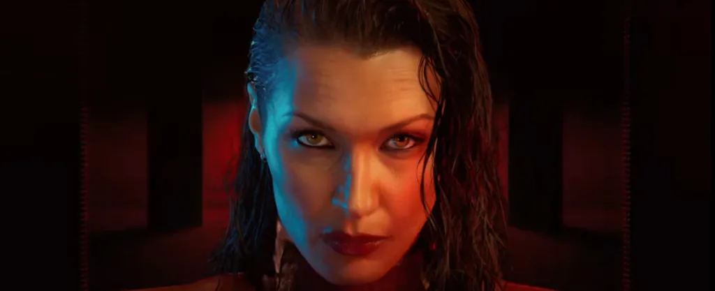 Close-up of a woman's face, illuminated by blue and red light, with wet hair and a serious expression.