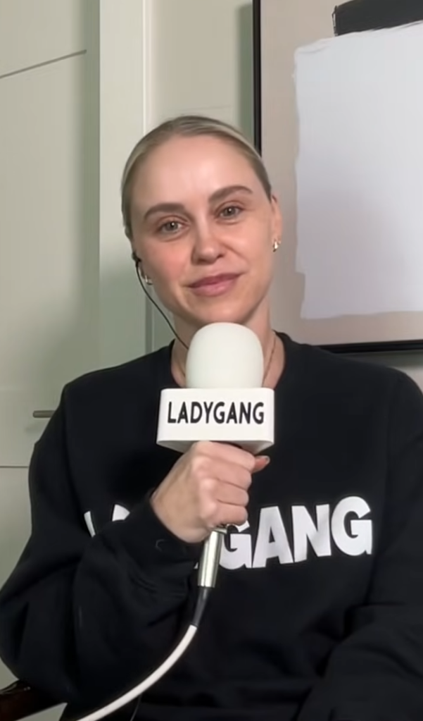 Becca Tobin holding a LadyGang microphone.