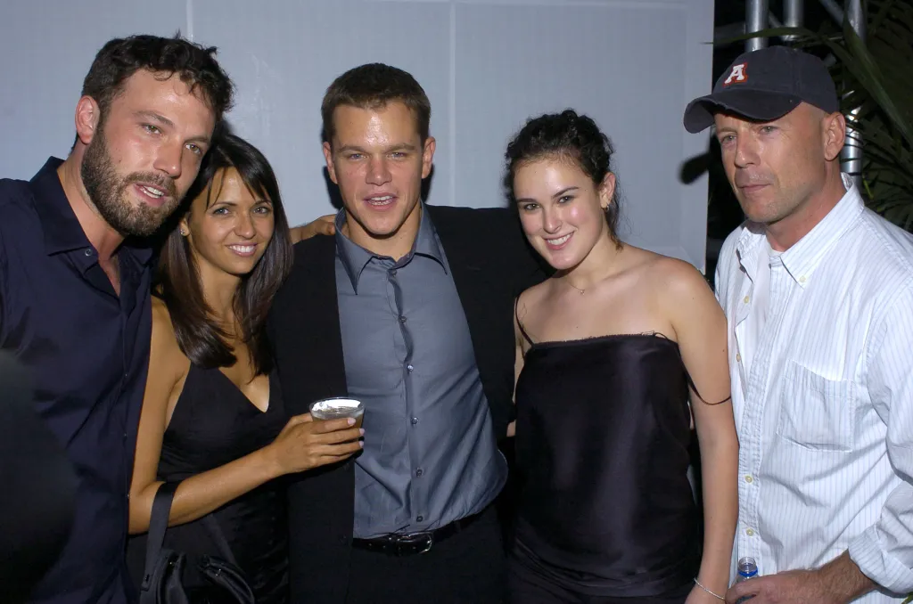 Ben Affleck, Luciana Bozan, Matt Damon, Rumer Willis, and Bruce Willis posing for a photo.
