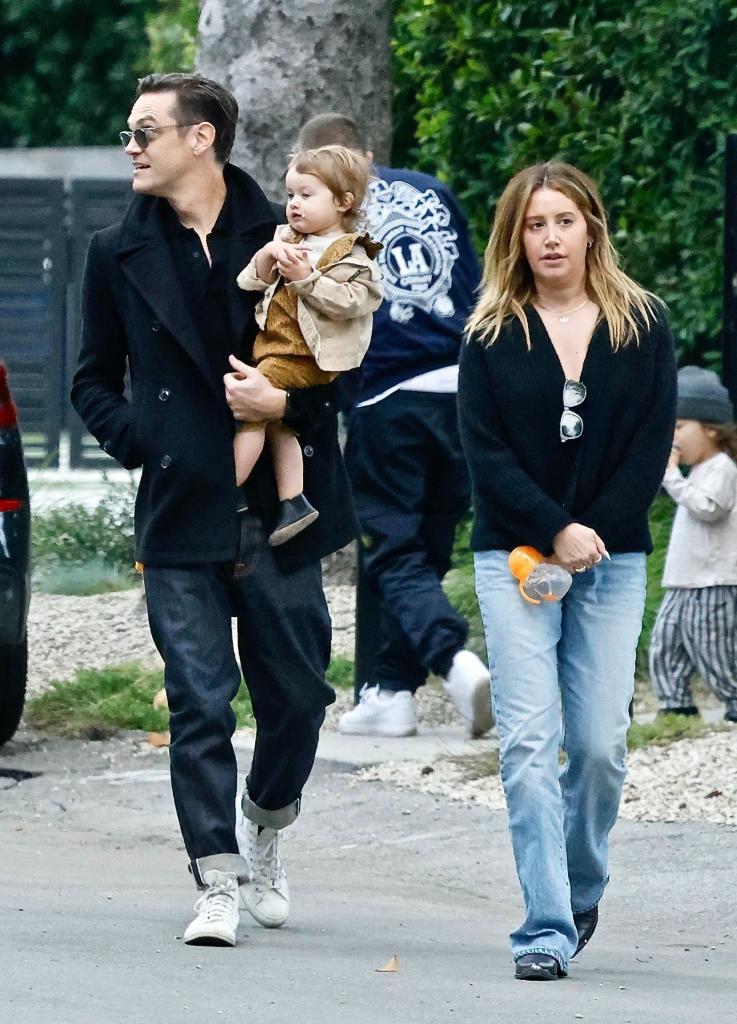 Christopher French holding his daughter, Jupiter, next to Ashley Tisdale.