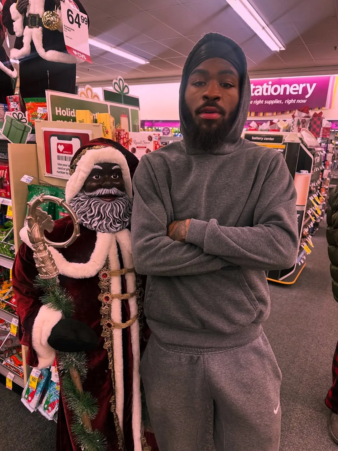 Twin Hector standing next to a Black Santa Claus decoration.