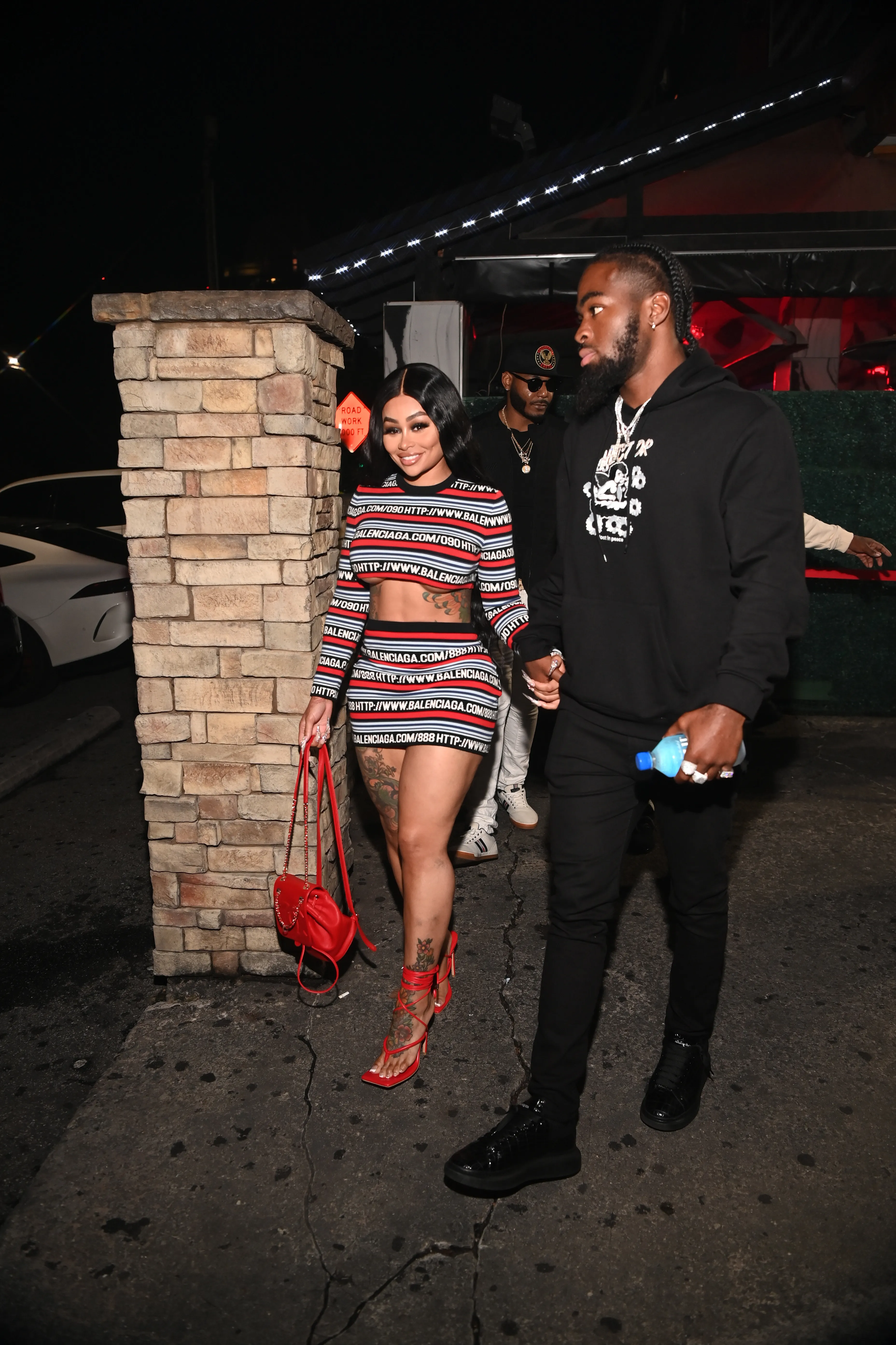 Blac Chyna and Lil Twin holding hands at Chaos Tuesdays.