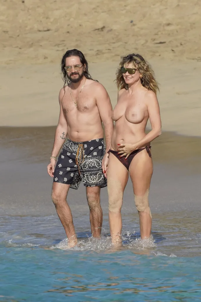 Heidi Klum and Tom Kaulitz walking along the beach in St. Barts.