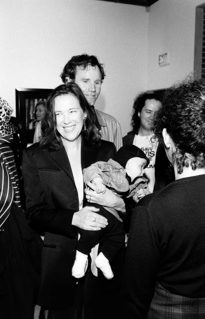 Catherine O'Hara holding Matthew Welch with Bo Welch behind her, at an event.