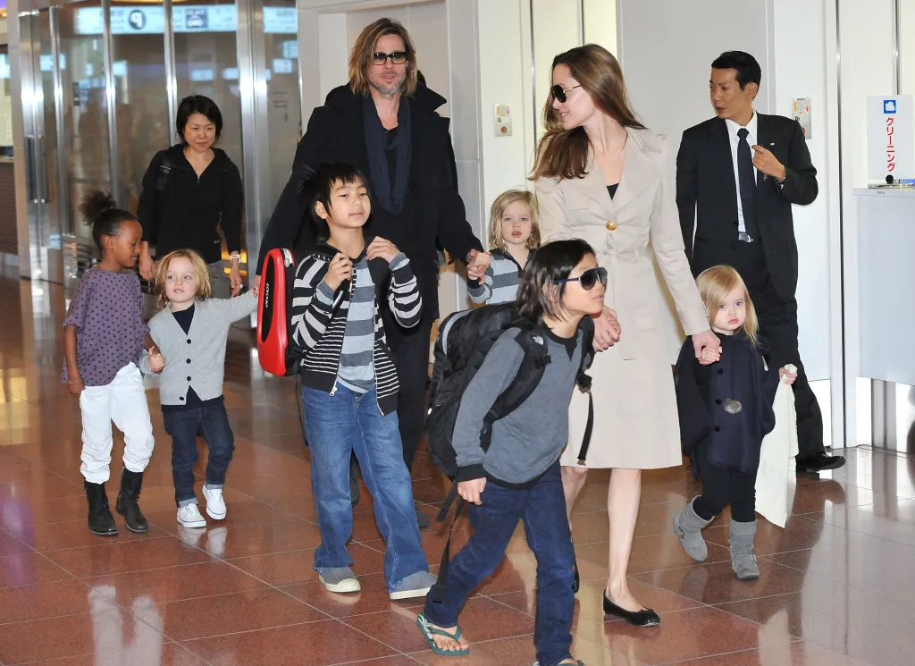 Brad Pitt and Angelina Jolie arriving in Tokyo with their six children.