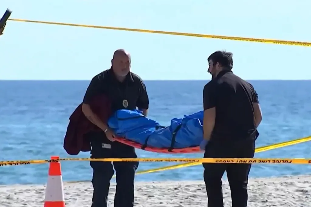 Officials remove the body of Heather Asendorf from a Hollywood Beach in Florida on Dec. 26, 2025.