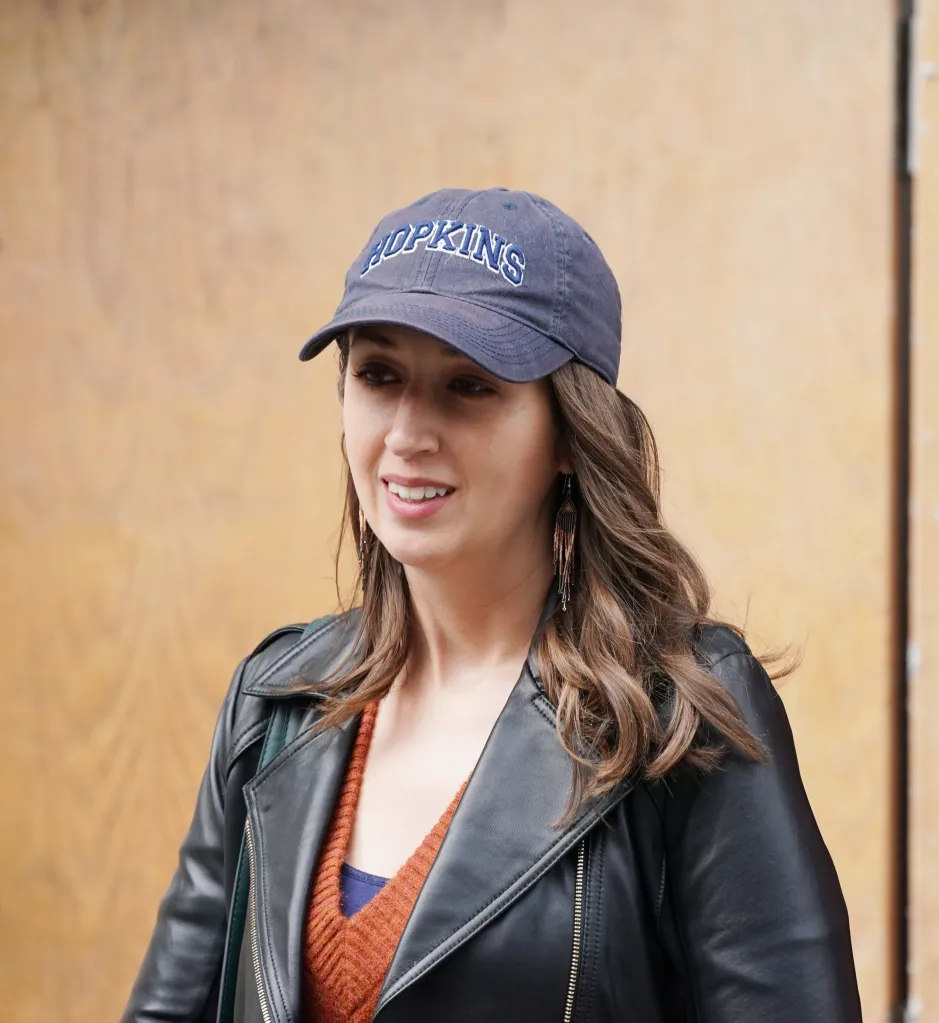 Brooke Nevils arrives at her apartment building in a black leather jacket and a 