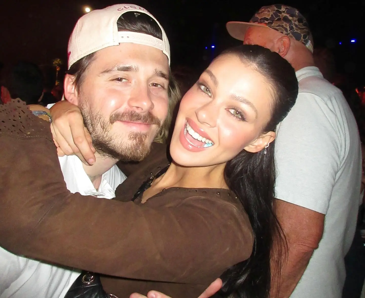 Brooklyn Beckham with his arm around Nicola Peltz.