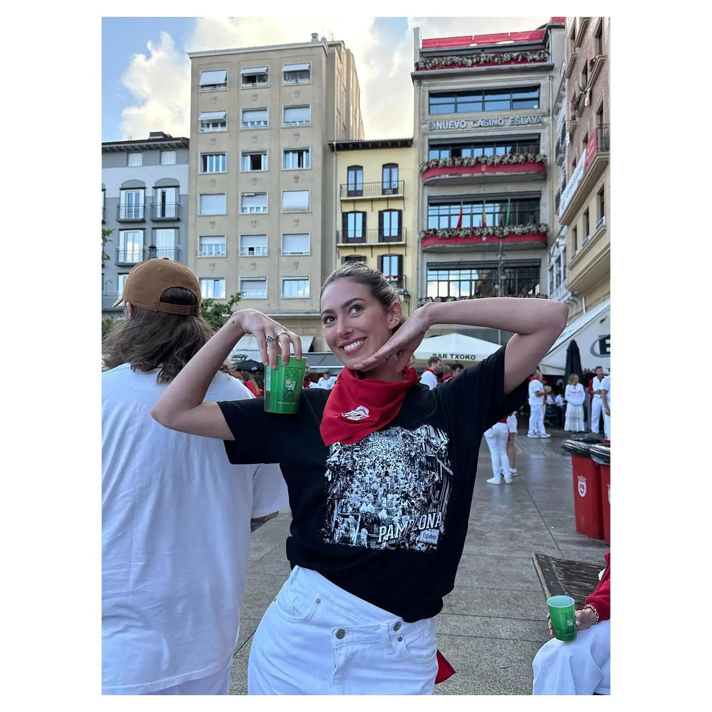 Samantha Leonard holding a drink and making a playful face while wearing a 