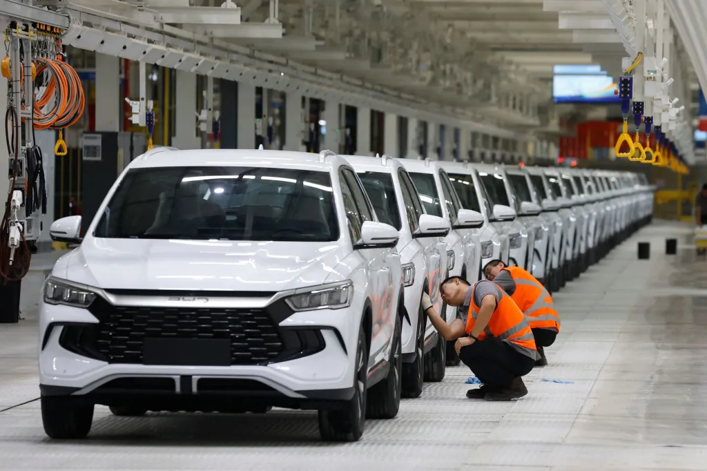 Workers cleaning electric vehicles in a BYD plant in Camacari, Brazil.