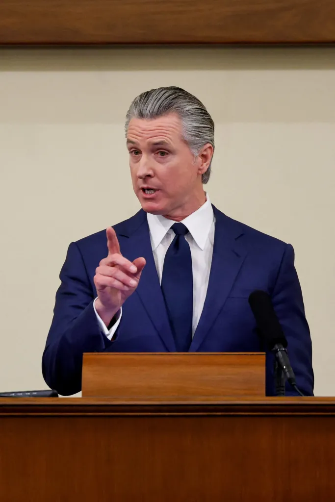 California Governor Gavin Newsom delivering the State of the State address in Sacramento, pointing his right index finger while speaking.