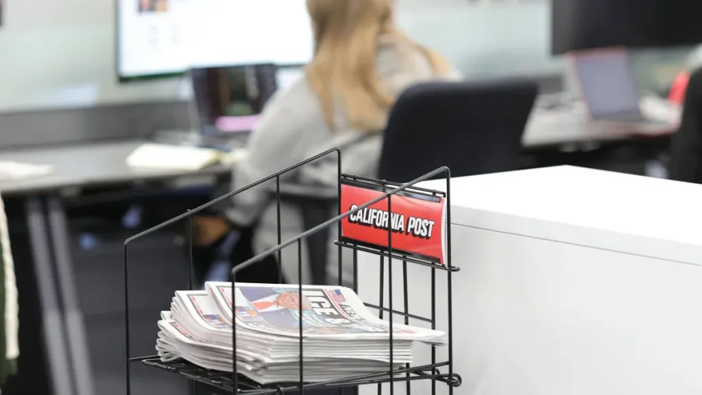 Dummy copies of the paper are scattered throughout the Post's newsroom