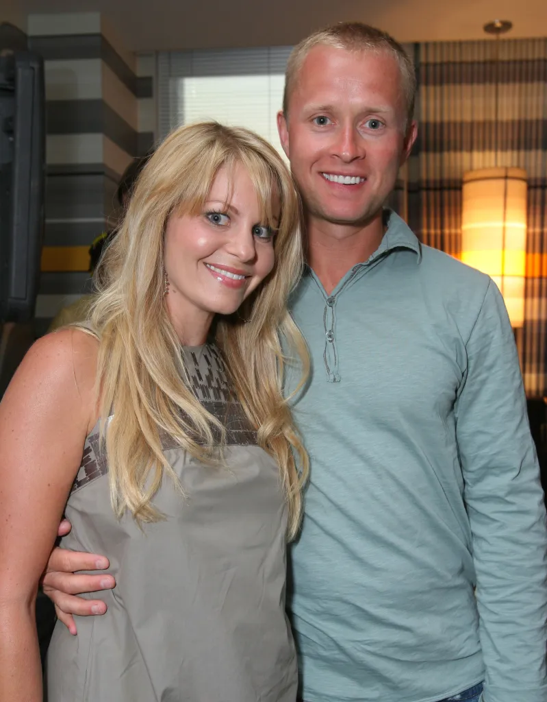 Candace Cameron Bure and husband Valeri Bure smiling with arms around each other.