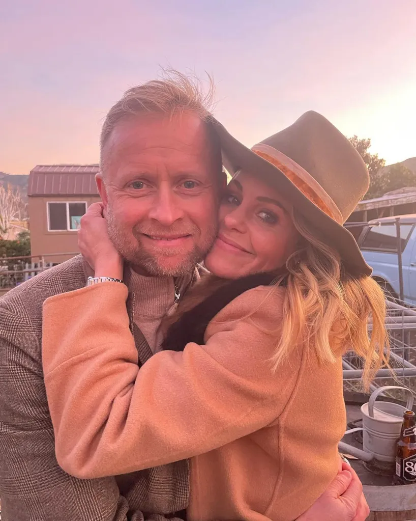 Candace Cameron Bure and her husband, Valeri Bure, embrace in a close-up outdoor photo.