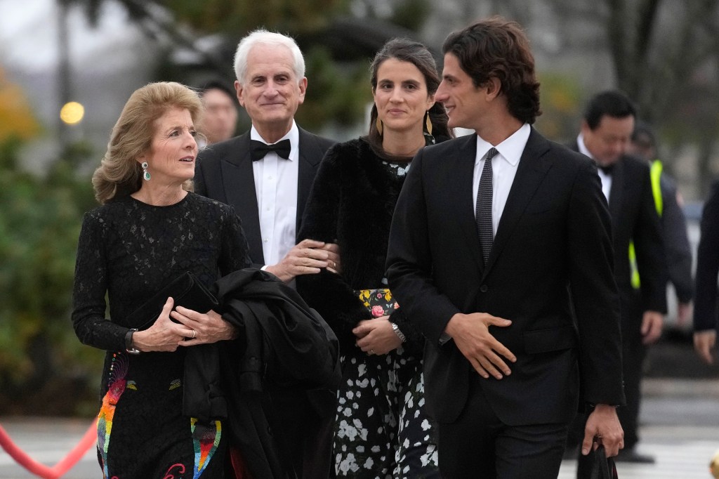 Caroline Kennedy, in a black gown, Edwin Schlossberg, in a black tuxedo, Tatiana Schlossberg, in a black top and patterned skirt, and Jack Schlossberg, in a black suit, arriving at the John F. Kennedy Presidential Library and Museum.