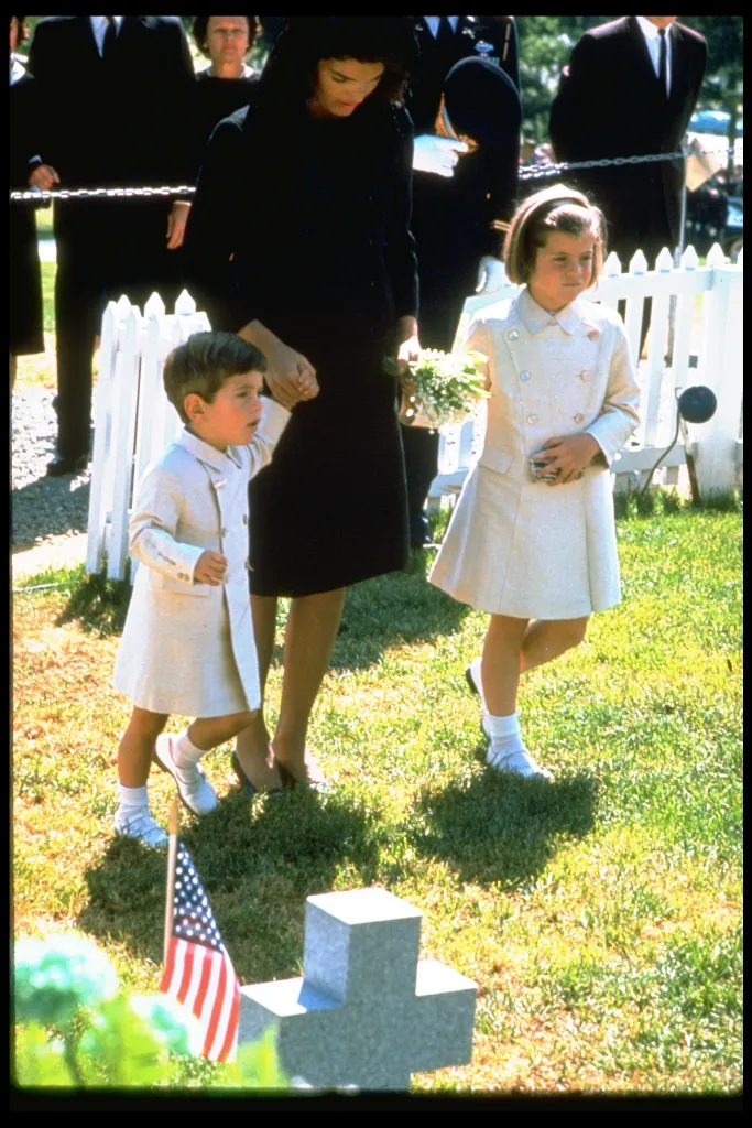 Jacqueline Kennedy with her children John Jr. and Caroline at the grave of John F. Kennedy.