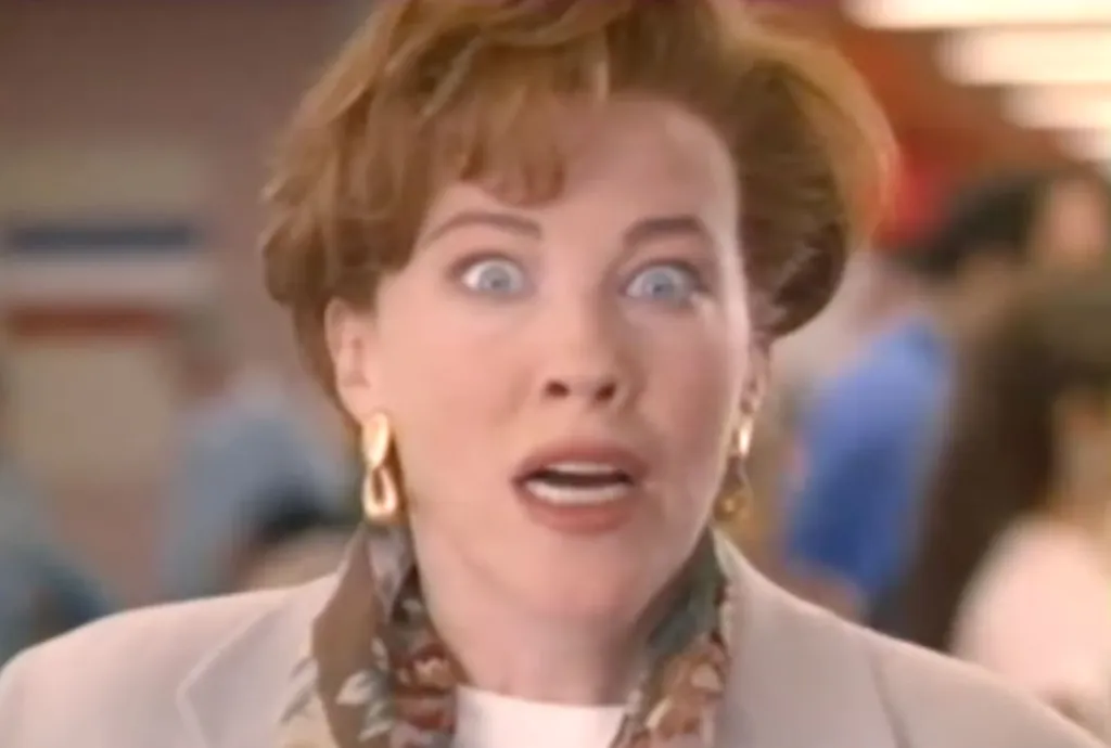Catherine O'Hara with a shocked expression, eyes wide and mouth open.
