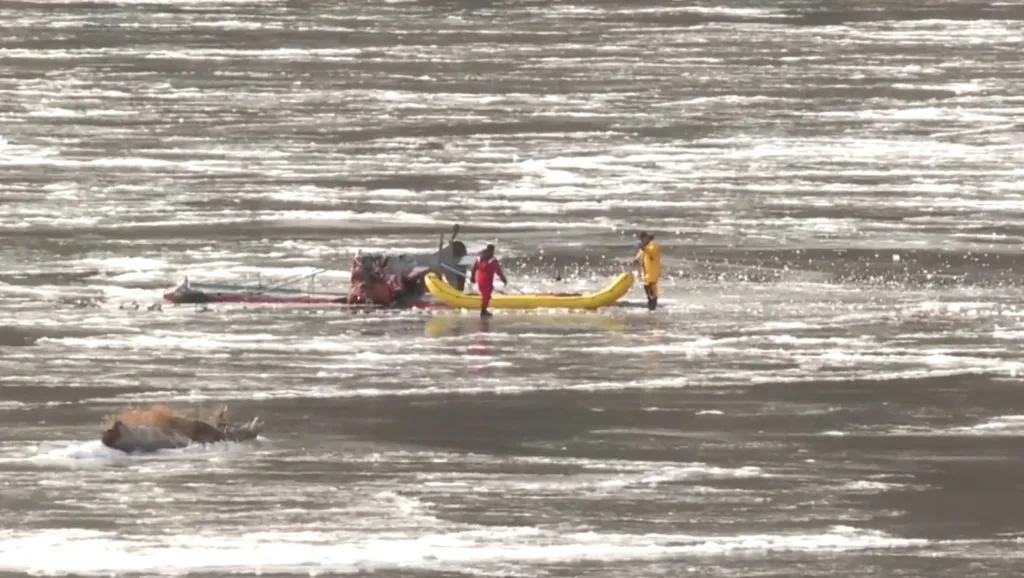 Recovery efforts in the icy Payette River following a plane crash.