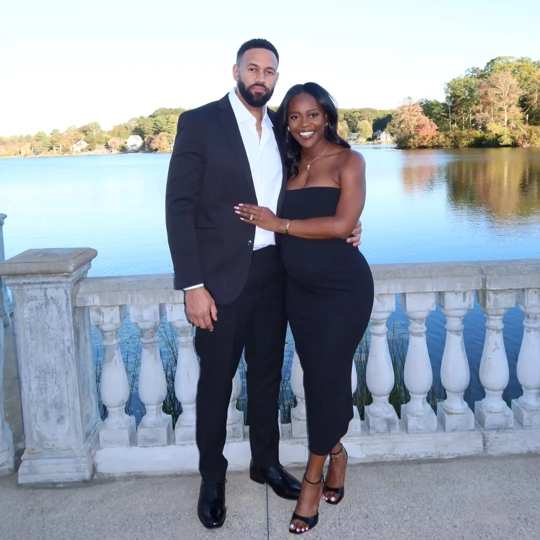 Amber Smith and Ollie Sutherland standing by a lake.