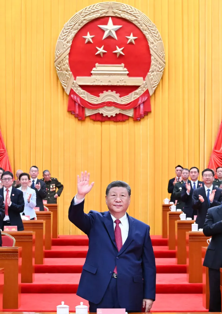 Chinese President Xi Jinping waving to a crowd during the 70th founding anniversary of the Xinjiang Uygur Autonomous Region.