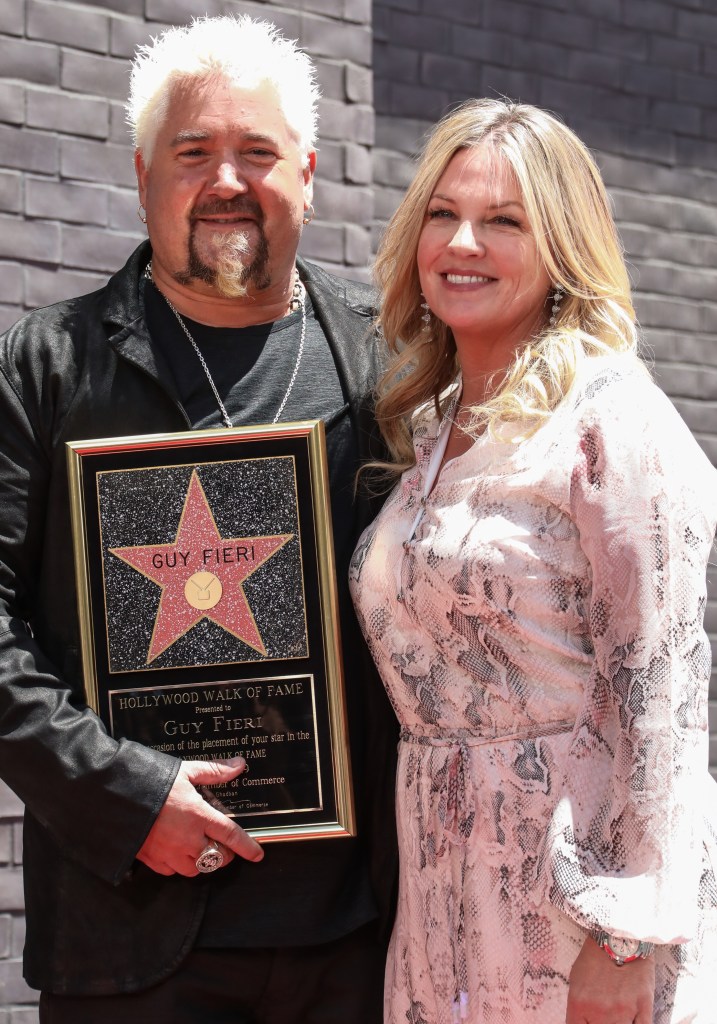 Guy Fieri and his wife Lori Fieri pose with his Hollywood Walk of Fame star.