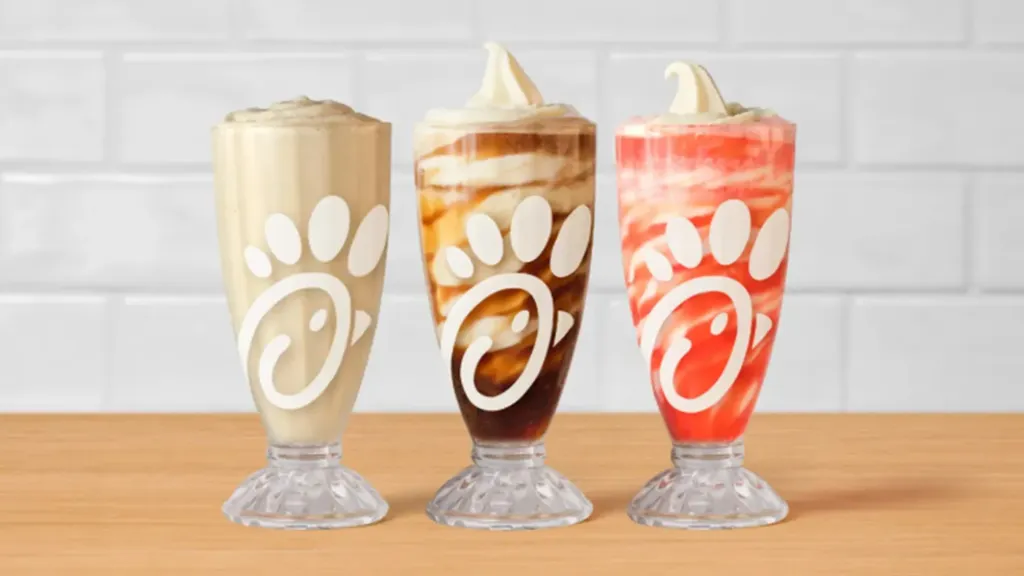 Three Chick-fil-A frosted drinks: frosted coffee, frosted soda, and frosted strawberry in retro cups.