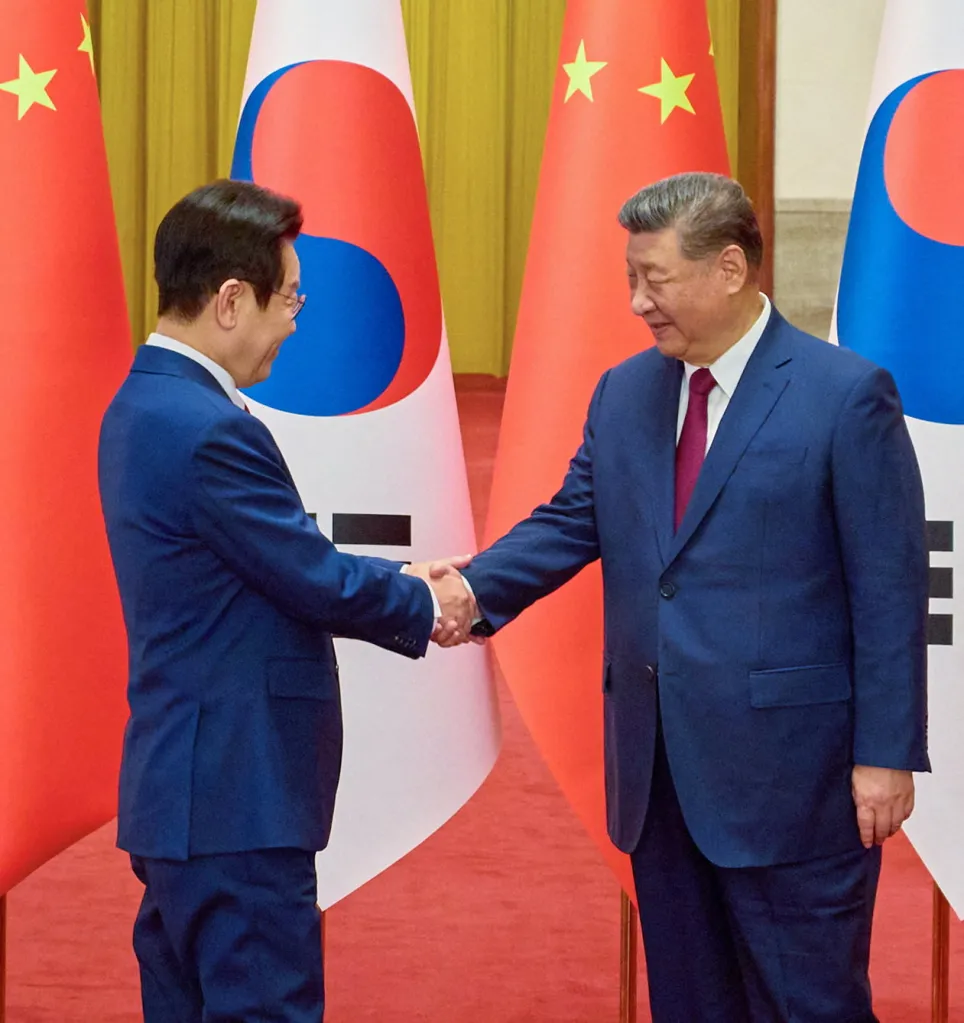 Chinese President Xi Jinping shakes hands with South Korean President Lee Jae Myung during a welcome ceremony at the Great Hall of the People in Beijing, China, January 5, 2026.