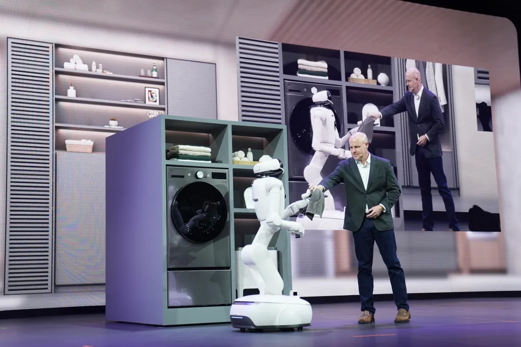 CLOiD robot receiving laundry from Brandt Varner.