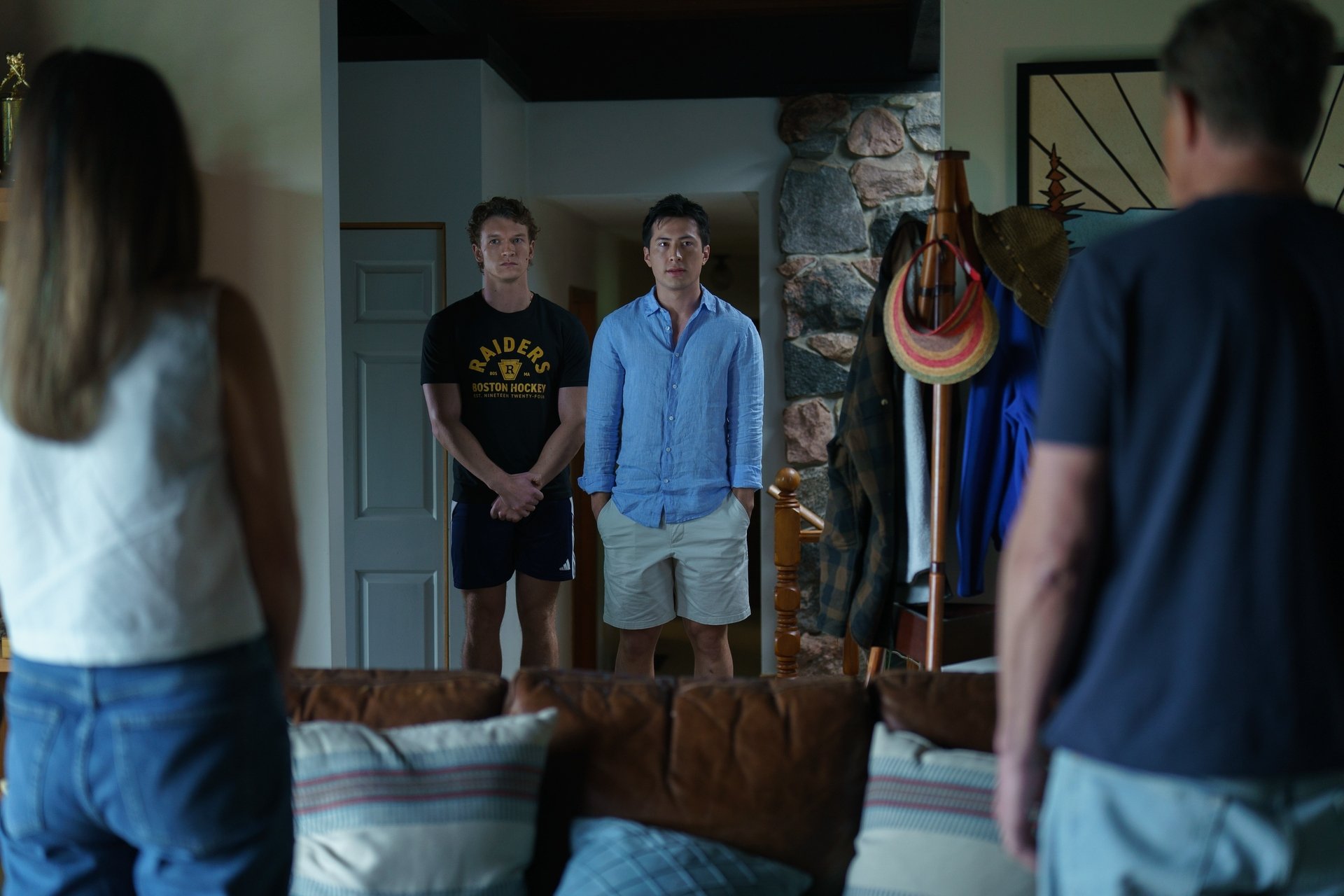 Connor Storrie as Ilya Rozanov and Hudson Williams as Shane Hollander look at two people with their backs to the camera.