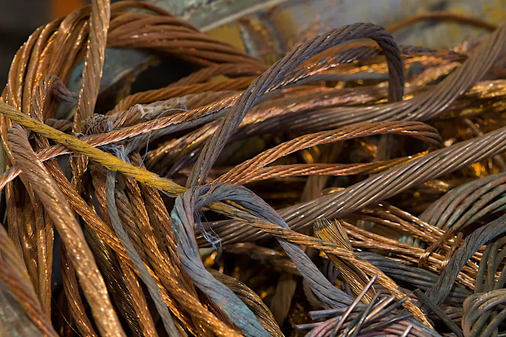 Bundles of copper wire in various shades of brown and gold, some with hints of green.