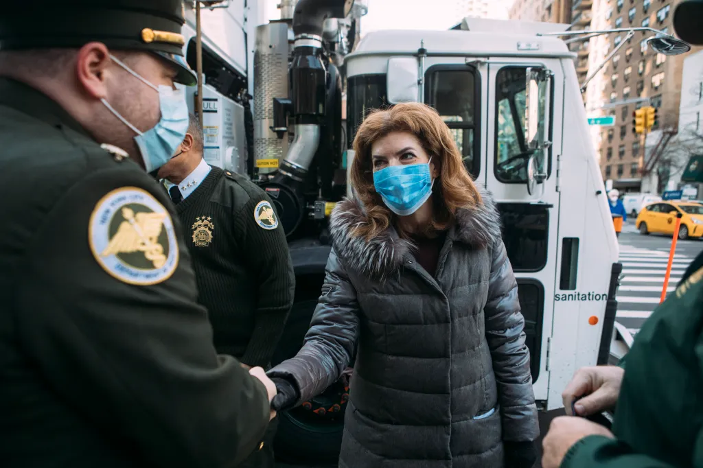 Council Member Julie Menin shaking hands with a DSNY officer.