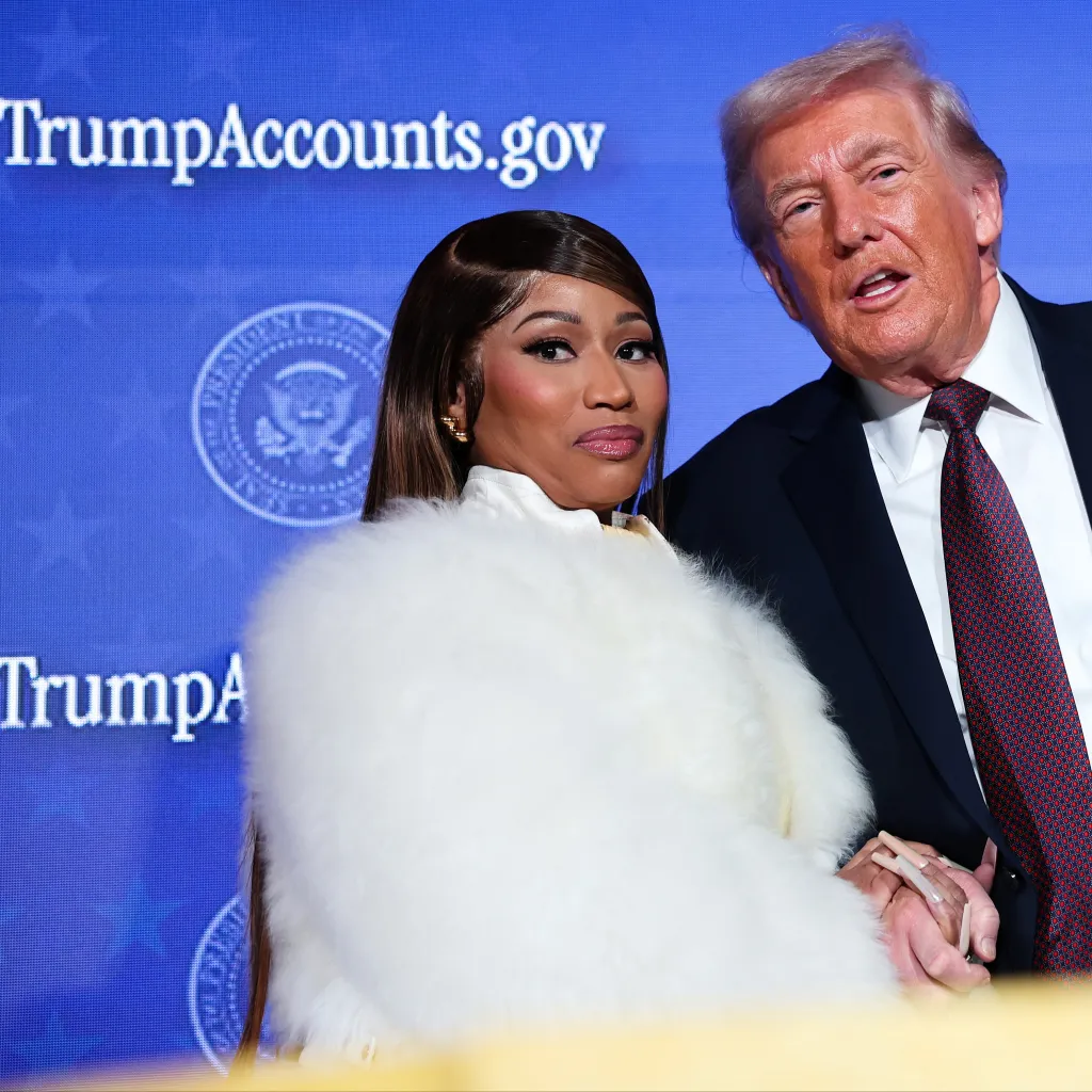 Nicki Minaj and Donald Trump posing together on stage at the Treasury Department's Trump Accounts Summit.