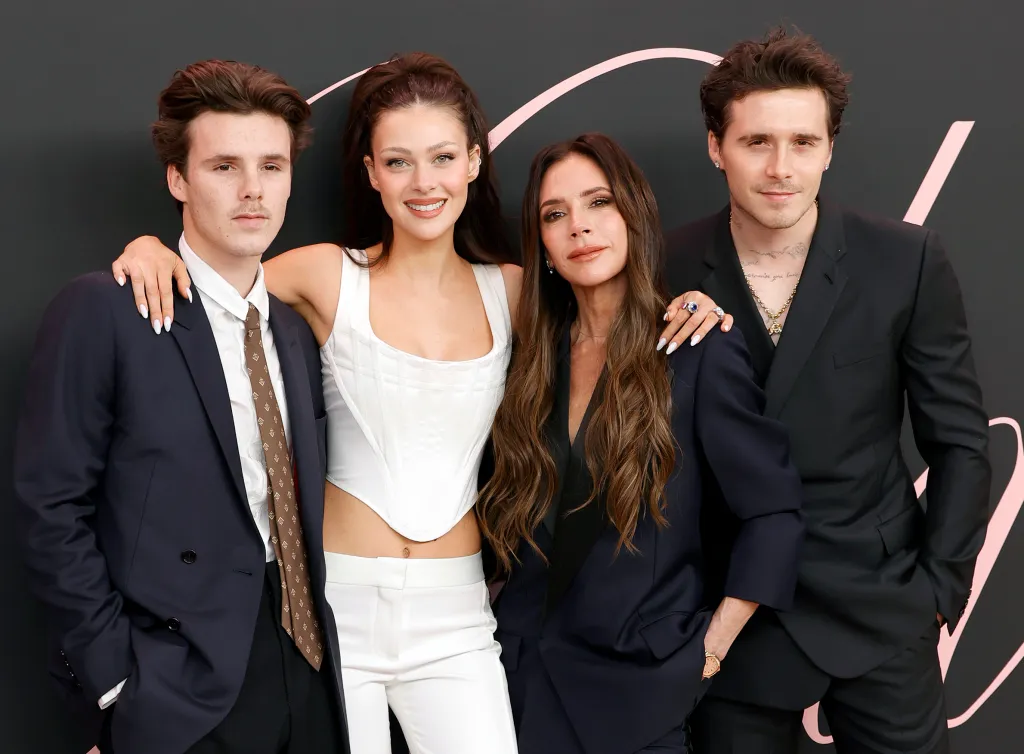 Victoria Beckham poses with Cruz Beckham, Nicola Peltz Beckham, and Brooklyn Peltz Beckham.