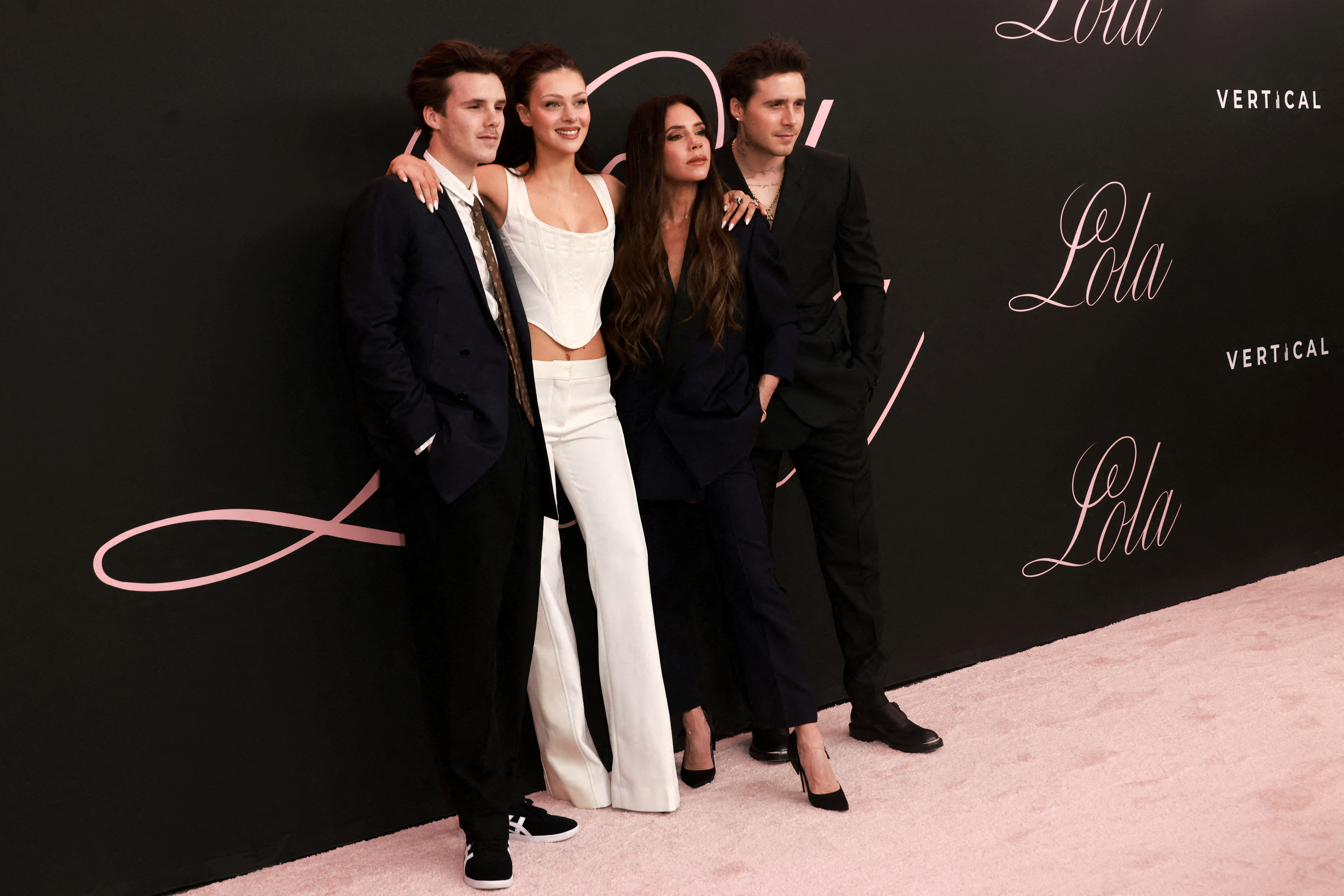 Cruz Beckham, Nicola Peltz, Victoria Beckham and Brooklyn Beckham pose on the red carpet at the premiere of 