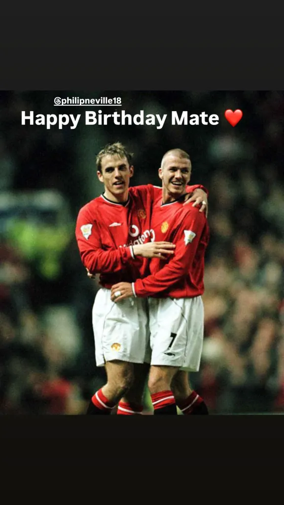David Beckham and Phil Neville embrace in their Manchester United kits.