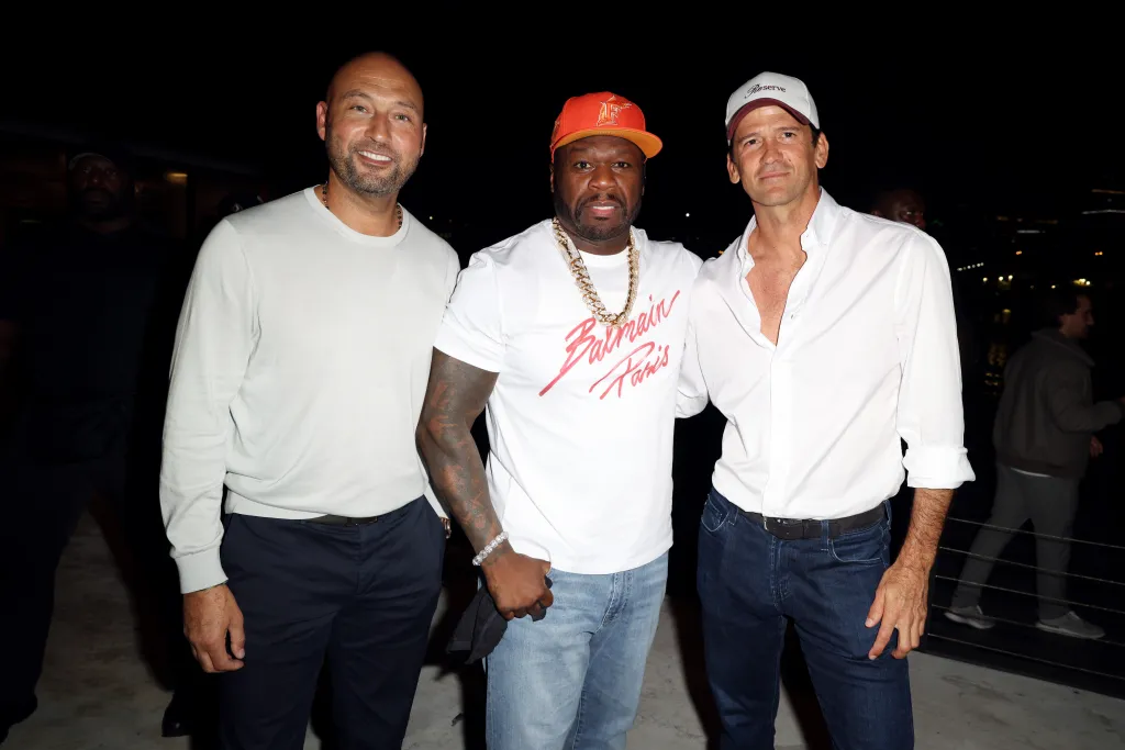 Derek Jeter, 50 Cent, and Wayne Boich posing together at the Reserve Cup Opening Night Post-Match Party.