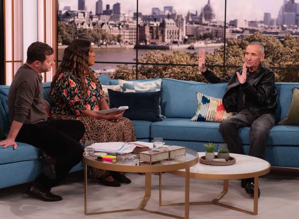 Dermot O'Leary, Alison Hammond, and Fat Tony on a TV show set.