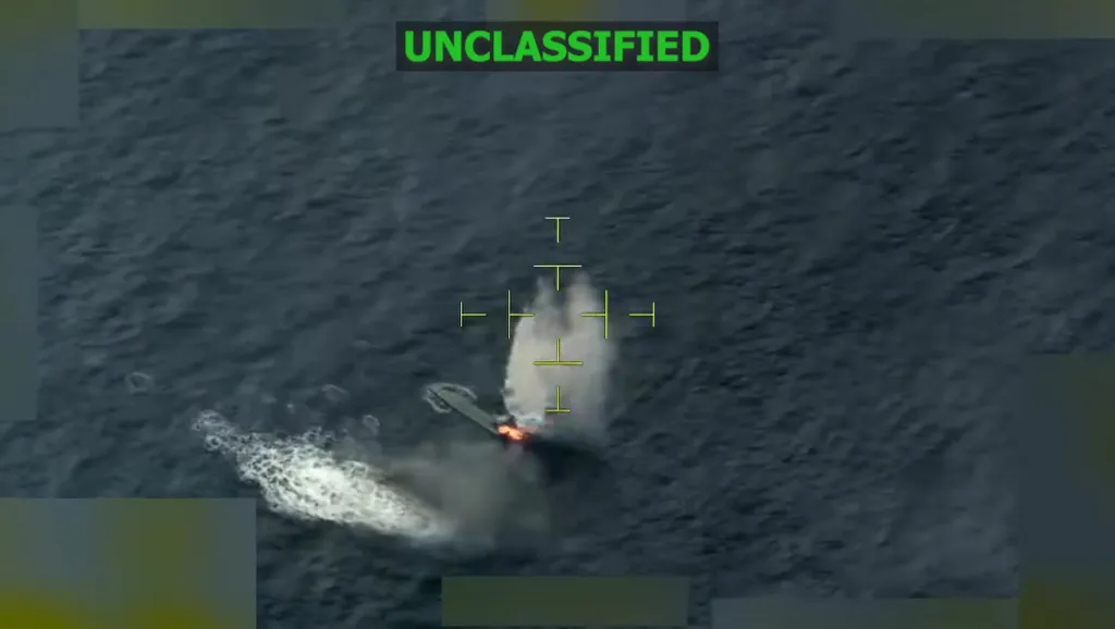 Aerial view of a boat exploding with flames and smoke in the ocean, targeted by crosshairs.