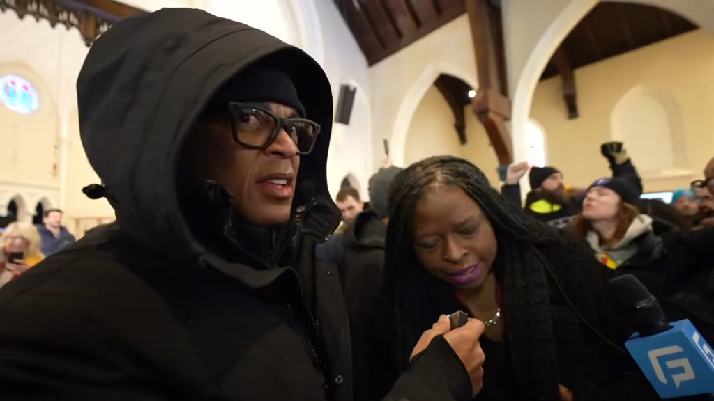 Don Lemon speaks with a protester inside a Minnesota Church on Jan. 18, 2026.