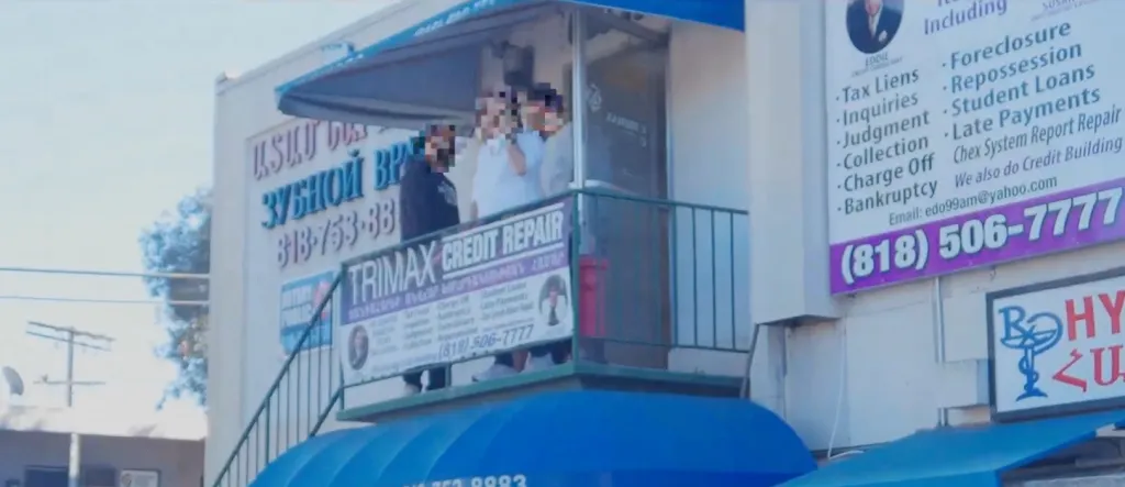 A business exterior with signs for credit repair services.