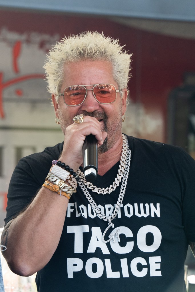 Guy Fieri wearing a black 