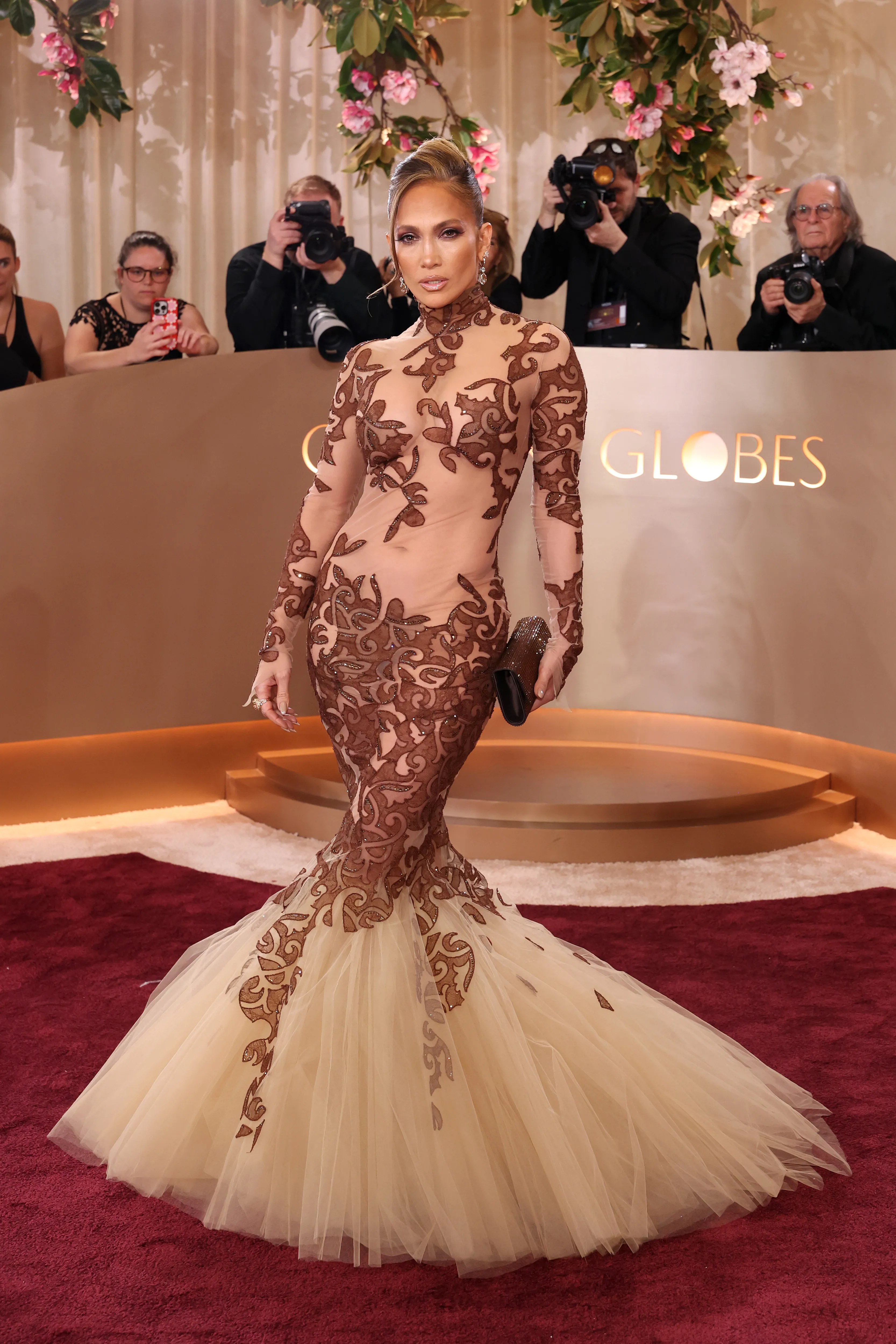 Jennifer Lopez in a sheer, brown and beige gown with a mermaid skirt at the 83rd Annual Golden Globe Awards.
