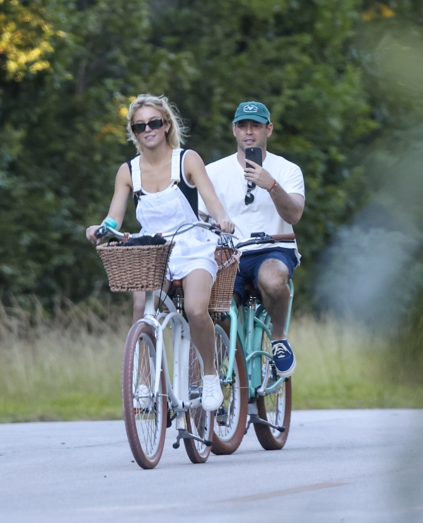 Sydney Sweeney and Scooter Braun riding bikes.